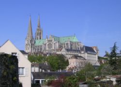 Chartres roofline and profile rises over the modern town.