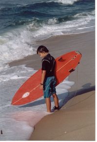 A young boy surfer