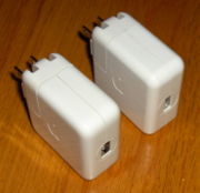 Two iPod wall chargers, with FireWire (left) and USB (right) connectors, which allow iPods to charge without a computer.
