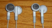 Two designs of iPod earbuds. The current version is shown on the right.