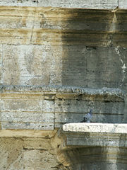 Between 1993 and 2000, parts of the outer wall were cleaned (left) to repair the Colosseum from automobile exhaust damage (right)
