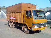 Tata 909 high deck covered rear load area truck