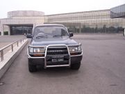 A RHD Toyota Landcruiser in front of a Pyongyang hotel