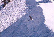 Snowboarder riding off cornice