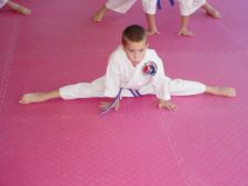 Stretching to increase flexibility is an important aspect of taekwondo training.