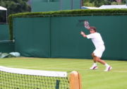 Roger Federer preparing to hit a forehand. Much can be learned from this photograph. Note how he is "loading" his body weight on his back (right) foot and coiling his shoulders with the help of his left hand. From this position, he will "uncoil" his body beginning with his legs, progressing to his hips and then on to his arms. This is how the "modern" forehand utilizing the open stance is executed.