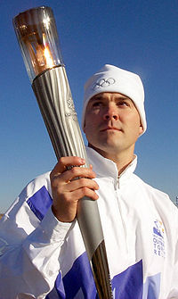An athlete carries the Olympic torch during the 2002 torch relay