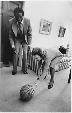 Globetrotters player Meadowlark Lemon presenting a ball signed by the team to First Lady Betty Ford in 1974.