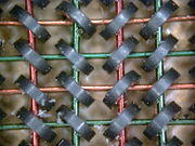 Magnetic core memory. Each core is one bit.