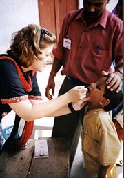 Child receiving an oral polio vaccine.