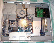 The internals of the original 20" iMac G5. Many hardware components can be seen.