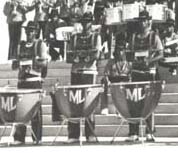 This 1976 photograph shows marching timpani grounded with legs extended.