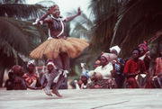 An African woman, wearing native garments, performs during a visit from participants in the West Africa Training Cruise 1983.