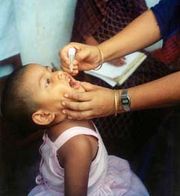 A child receives oral polio vaccine