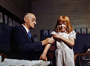 Doctor administering a typhoid vaccination at a school in San Augustine County, Texas.  Photograph by John Vachon, April 1943.