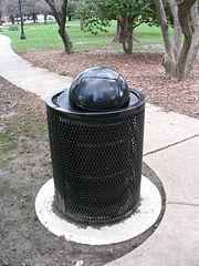 A trash can in a park