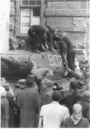 Hungarians inspecting a captured Soviet T-34-85 tank in Budapest