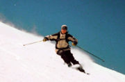 Alpine skier carving a turn on piste