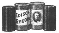 Two Edison cylinder records (on either end) and their cardboard storage cartons (center).