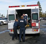 Emergency medical technicians evacuating an injured skier from a ski area