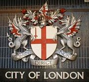 Coat of arms of the City of London at Blackfriars station. The Latin motto reads Domine Dirige Nos, "Lord, guide us". The red sword is commonly supposed to commemorate the killing of Peasants' Revolt leader Wat Tyler by the Lord Mayor of London William Walworth in 1381, but in fact is the symbol of the martyrdom of Saint Paul, London's patron saint.