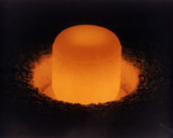 A pellet of plutonium-238, glowing due to blackbody radiation, used for radioisotope thermoelectric generators.