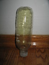 Chlorine gas in a transparent plastic container. It is not advisable to store chlorine in this manner.