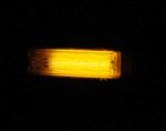 A low pressure sodium lamp, glowing with the light of sodium D spectral lines.