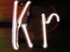 A krypton filled discharge tube in the shape of the element's atomic symbol.