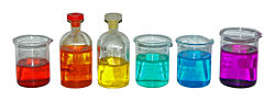 From left to right, aqueous solutions of:  Co(NO3)2 (red); K2Cr2O7 (orange); K2CrO4 (yellow); NiCl2 (green); CuSO4 (blue); KMnO4 (purple).