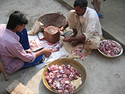 Distribution of meat of a traditionally sacrificed animal to the poor in Pakistan