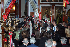 The congregation lighting their candles from the new flame in Adelaide, at St. George Greek Orthodox Church, just as the priest has retrieved it from the altar - note that the picture is flash-illuminated; all electric lighting is off, and only the oil lamps in front of the Iconostasis remain lit.