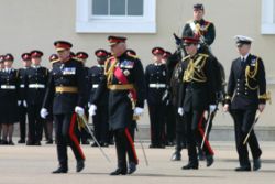 Officer Cadet Wales (standing to attention next to the horse) on parade at Sandhurst, 21 June 2005.