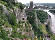 Avon Gorge and Clifton Suspension Bridge, looking towards the city of Bristol. The people are looking out of the Giants Cave view point on the gorge face.
