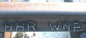 In 2004, initials of VGN founders Henry Huttleston Rogers and William Nelson Page were engraved by volunteers in newly laid rail at Victoria, Virginia, where fully-equipped and restored former VGN Class 10-A caboose #342 is now displayed. photo by Tom Salmon of Virginian Railway Enthusiasts on Yahoo