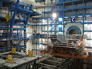 ATLAS experiment detector under construction in October 2004 in its experimental pit; the current status of construction can be seen here. Note the people in the background, for comparison.