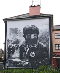 A mural showing a boy in a gas mask during the Battle of the Bogside.