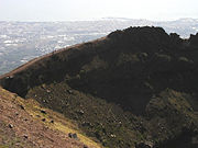 A view of the crater wall of Vesuvius, with Naples in the background