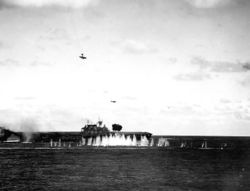 A damaged Japanese Val dive bomber (upper left) dives towards Hornet at 09:14...