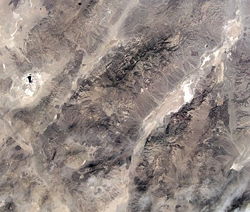 The Death and Panamint valleys area from space. The elliptical depression to the left is the Searles Lake basin, the smaller linear valley is Panamint Valley and the larger one is Death Valley. The mountain range between Death and Panamint valleys is the Panamint Range, and the Black Mountains bound the other side of Death Valley. (NASA image)