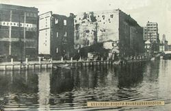 West side of the Sihang Warehouse, riddled with bullet and artillery holes. The New Lese Bridge is to the right of main building.