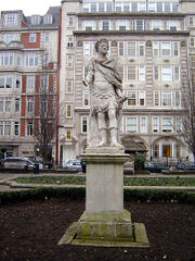 Statue of George II in Golden Square, Soho, London. By John Nost the elder, this was erected in 1753, but had actually been made 33 years previously for the Duke of Chandos. It is badly corroded (it has been suggested that this is due to over-zealous cleaning) and the right hand is damaged. The only other public statue of this king in London is at the Royal Naval College in Greenwich. (January 2006)