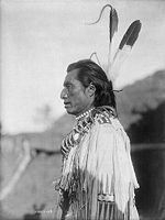 Crow's Heart, a Mandan, circa 1908. He is wearing a traditional deerskin tunic. Photographed by Edward S. Curtis.