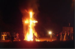 Klansmen and women at a cross burning in 2005.
