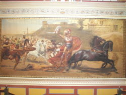 Triumphant Achilles dragging Hector's lifeless body in front of the Gates of Troy. (From a panoramic fresco on the upper level of the main hall of the Achilleion)