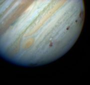 Brown spots mark impact sites of the Shoemaker-Levy Comet on Jupiter's southern hemisphere.