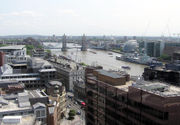 Tower Bridge in its river setting, looking east from the viewing platform of The Monument. City Hall is the building shaped like a motorcycle helmet, and below it is HMS Belfast.