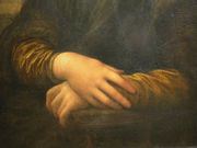 Detail of Lisa's hands, her right hand resting on her left hand. Leonardo chose this gesture rather than a wedding ring to depict Lisa as a virtuous woman and faithful wife.