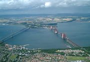 The Forth Bridges, with the road bridge crossing to the left of the rail bridge.
