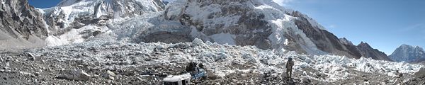 A view of Everest southeast ridge base camp. The Khumbu Icefall can be seen in the left. In the center are the remains of a helicopter that crashed in 2003.